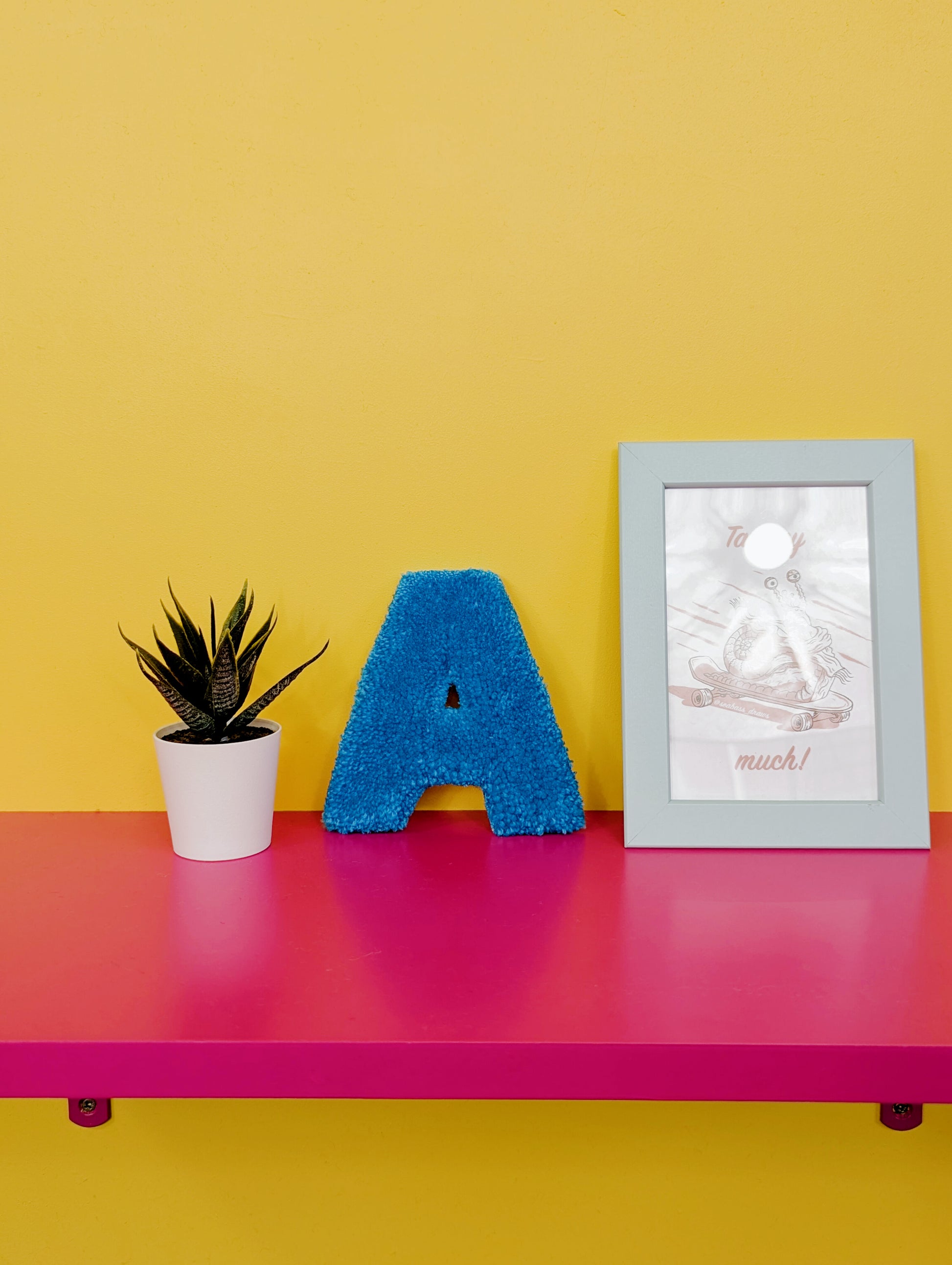 Soft tufted blue letter A with metal hook for easy hanging