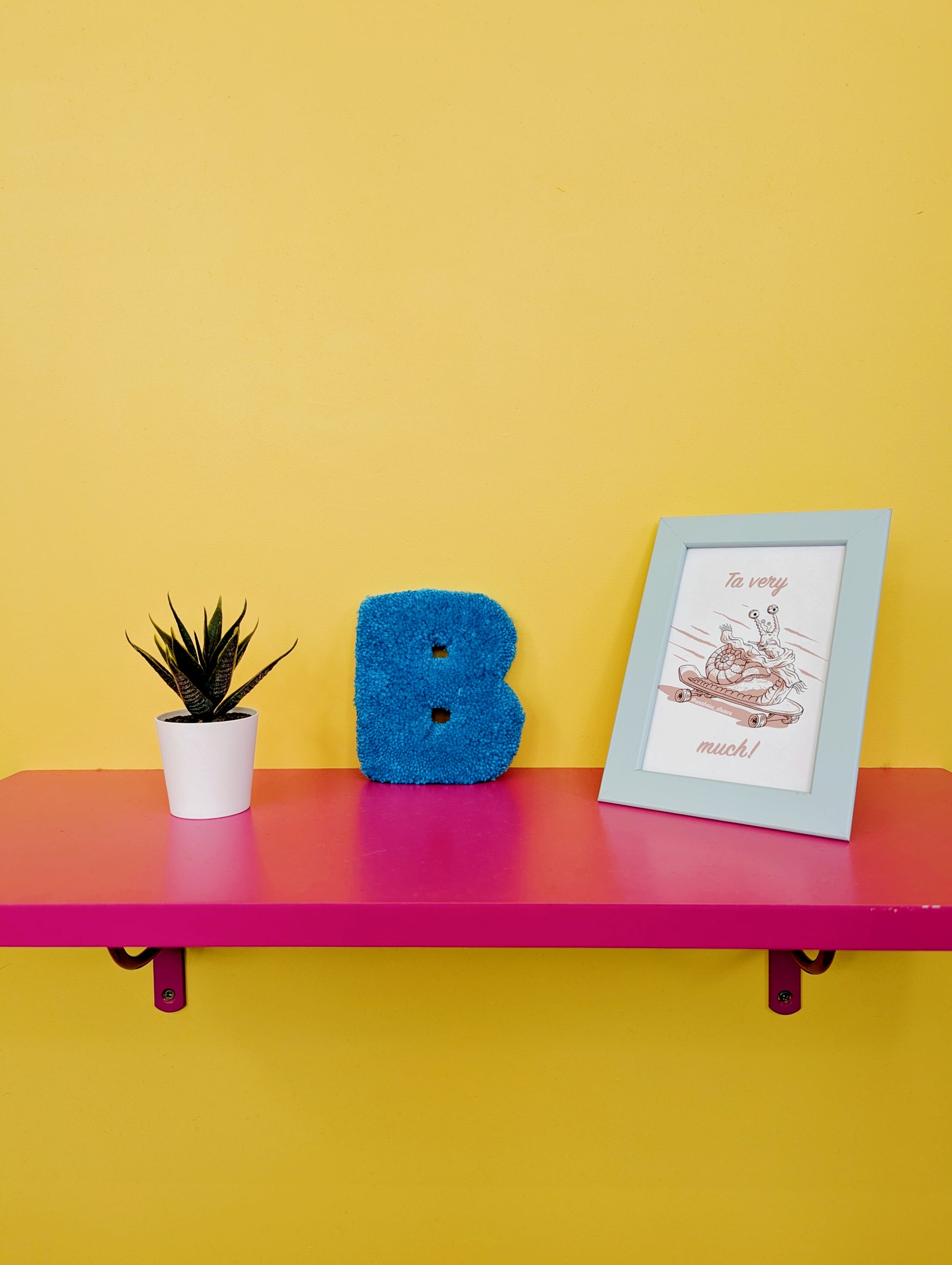 Soft tufted blue letter B with metal hook for easy hanging