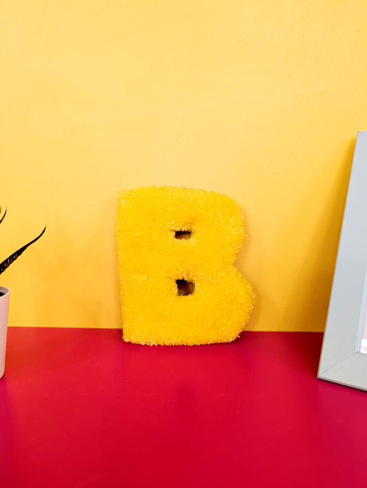 Soft tufted yellow letter B with metal hook for easy hanging