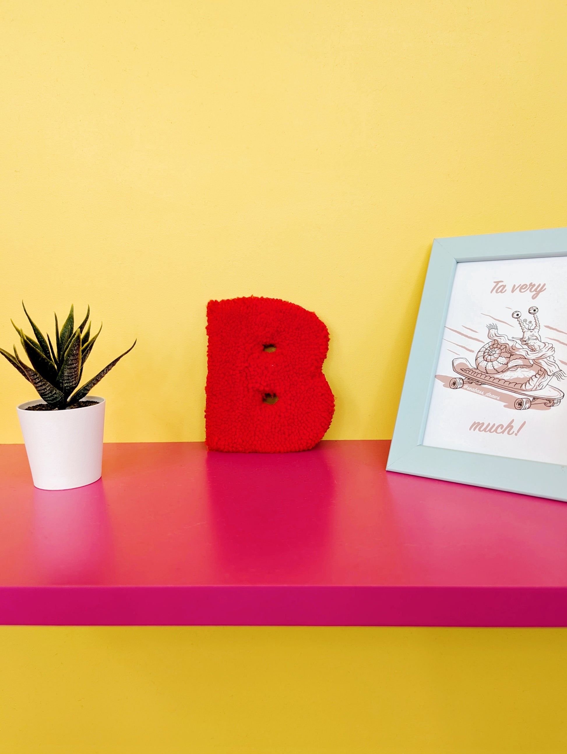Soft tufted red letter B with metal hook for easy hanging