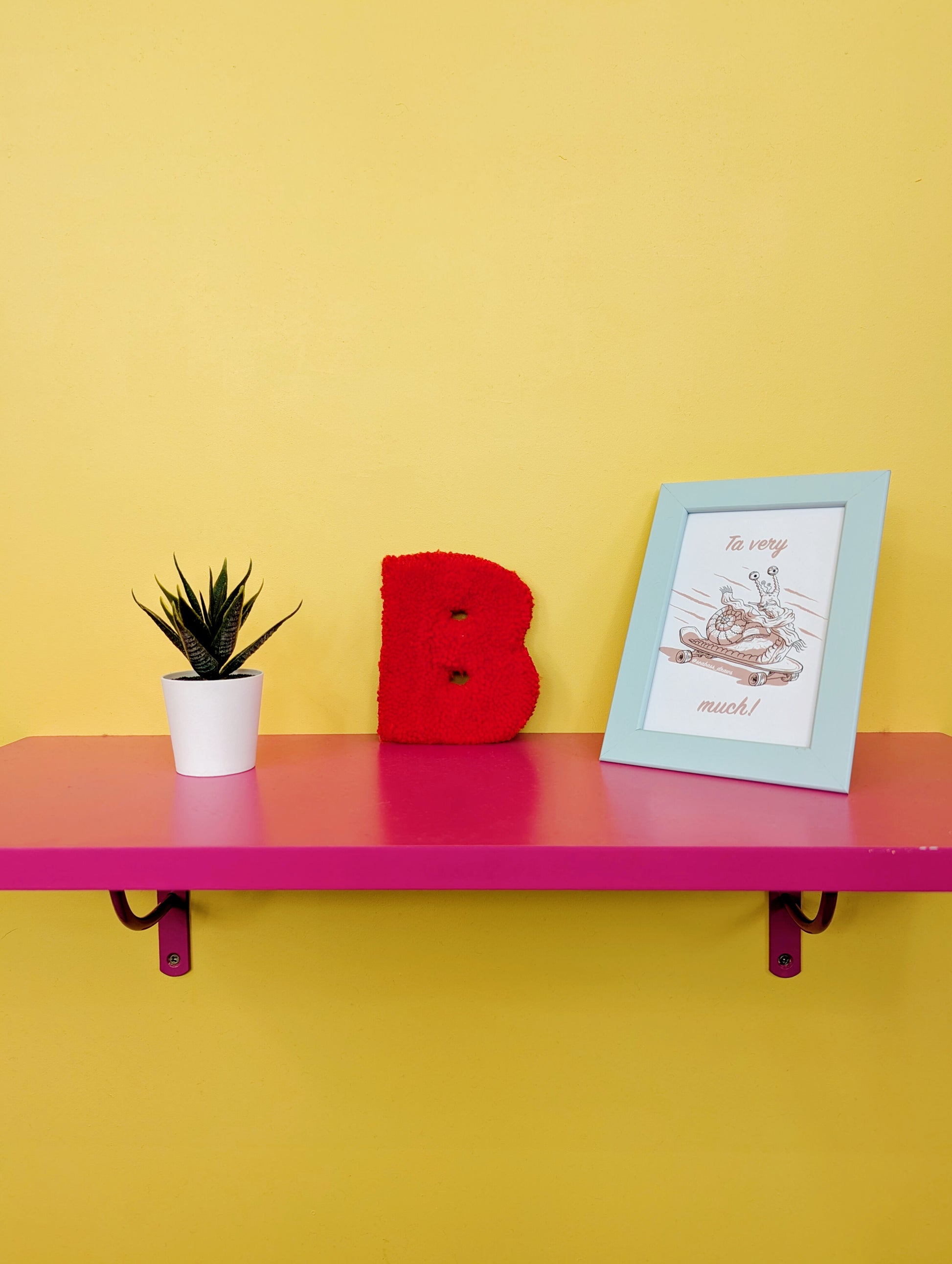 Soft tufted red letter B with metal hook for easy hanging