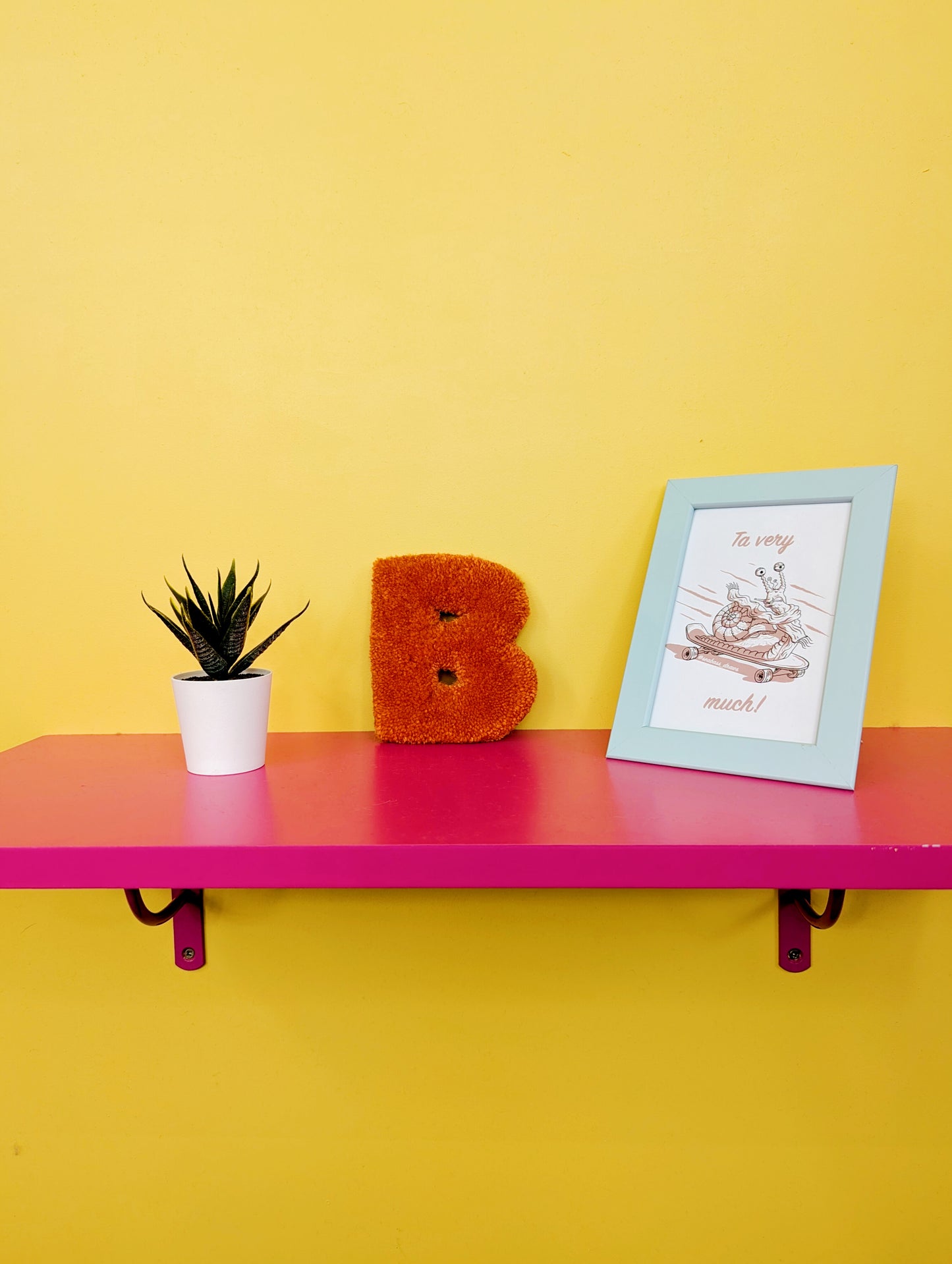 Soft tufted orange letter B with metal hook for easy hanging