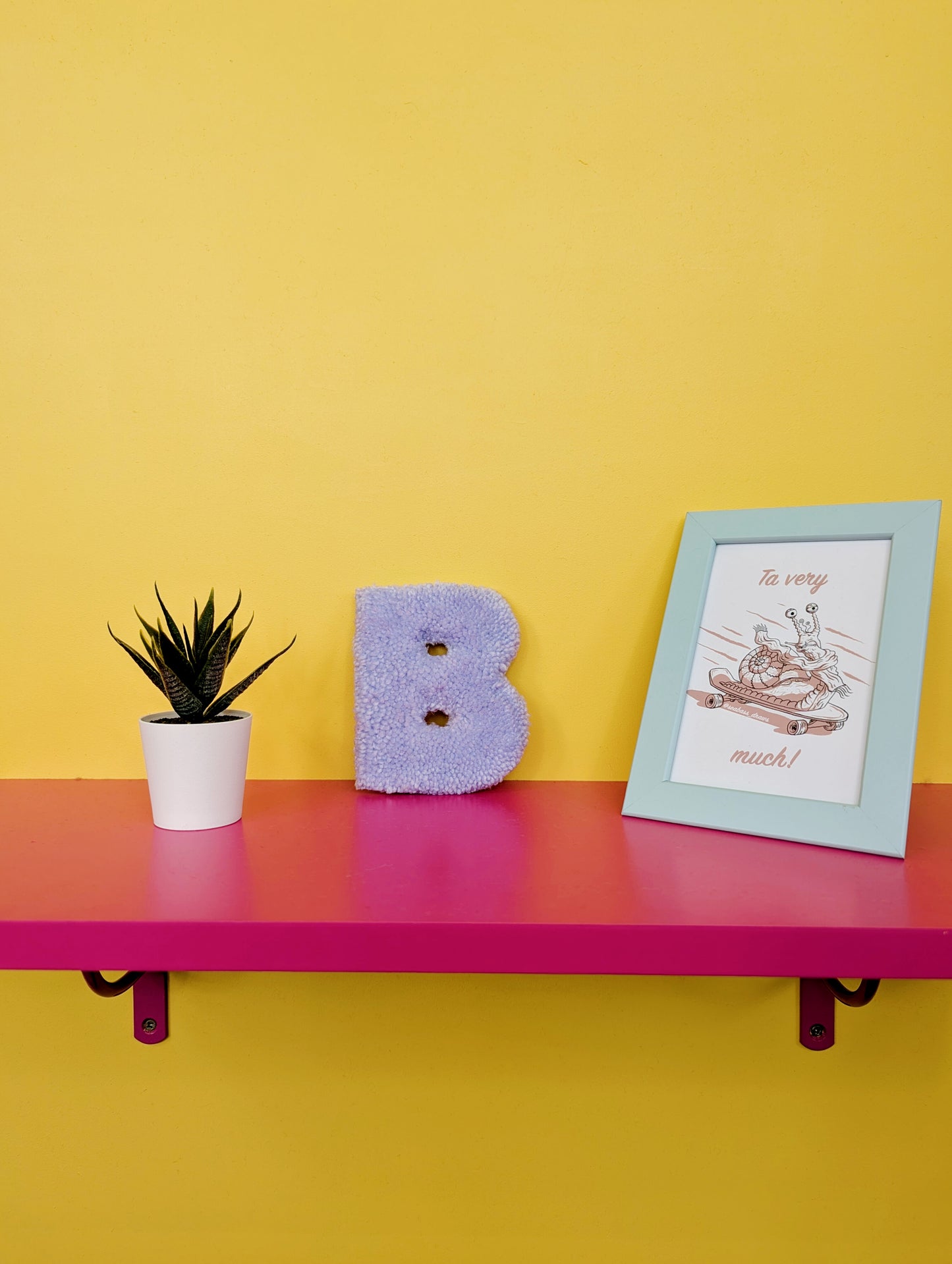 Soft tufted purple letter B with metal hook for easy hanging