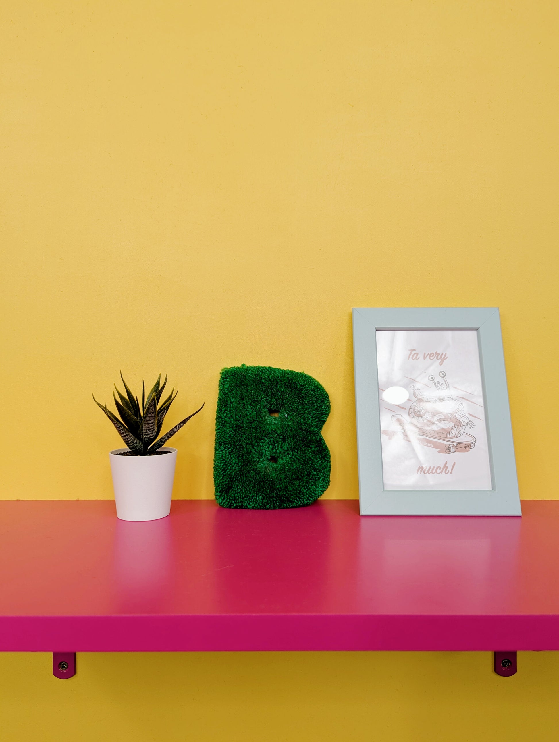 Soft tufted green letter B with metal hook for easy hanging