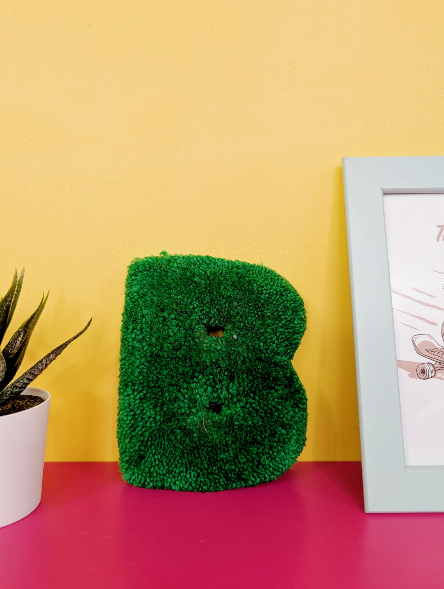 Soft tufted green letter B with metal hook for easy hanging