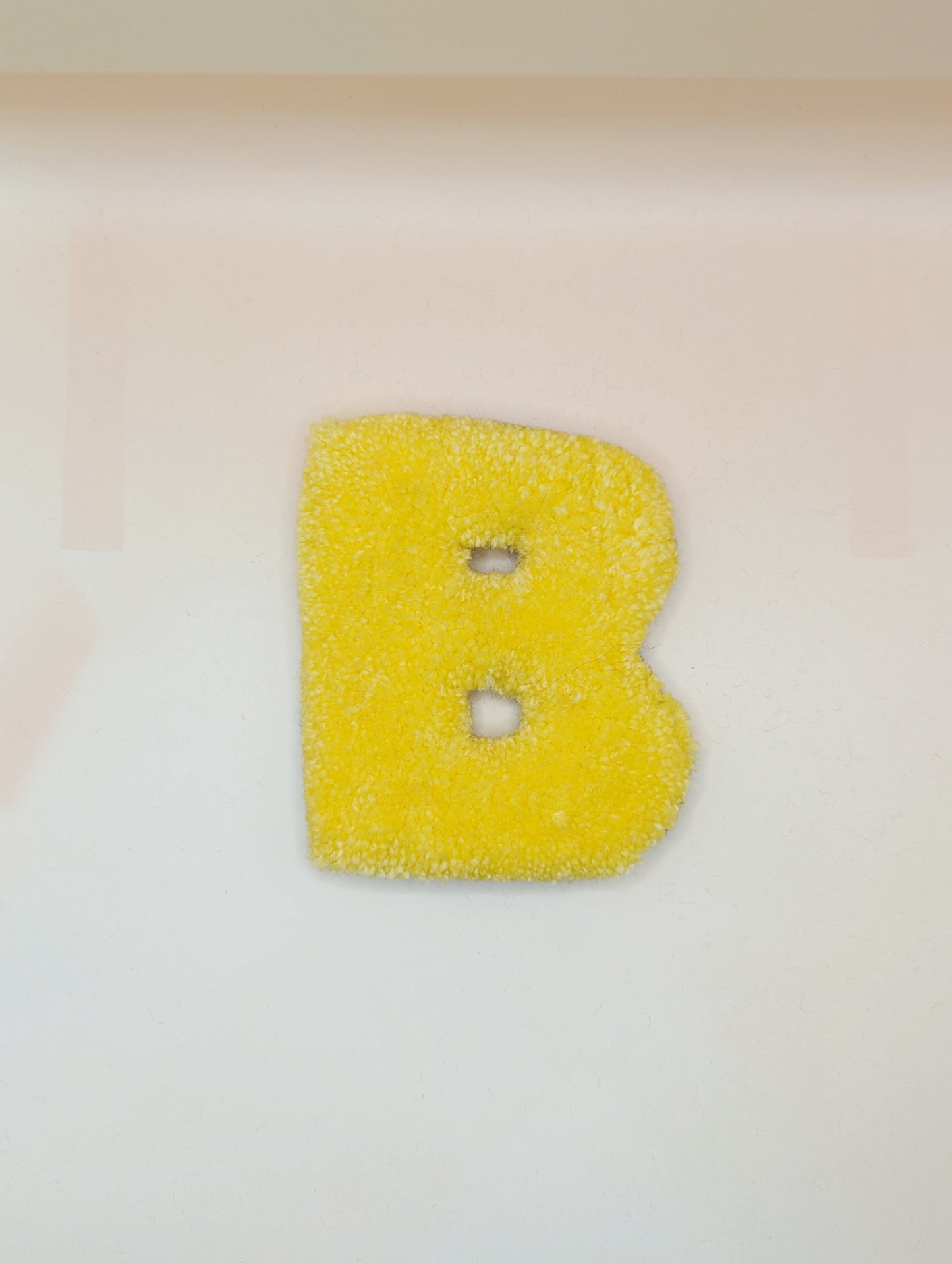 Soft tufted yellow letter B with metal hook for easy hanging