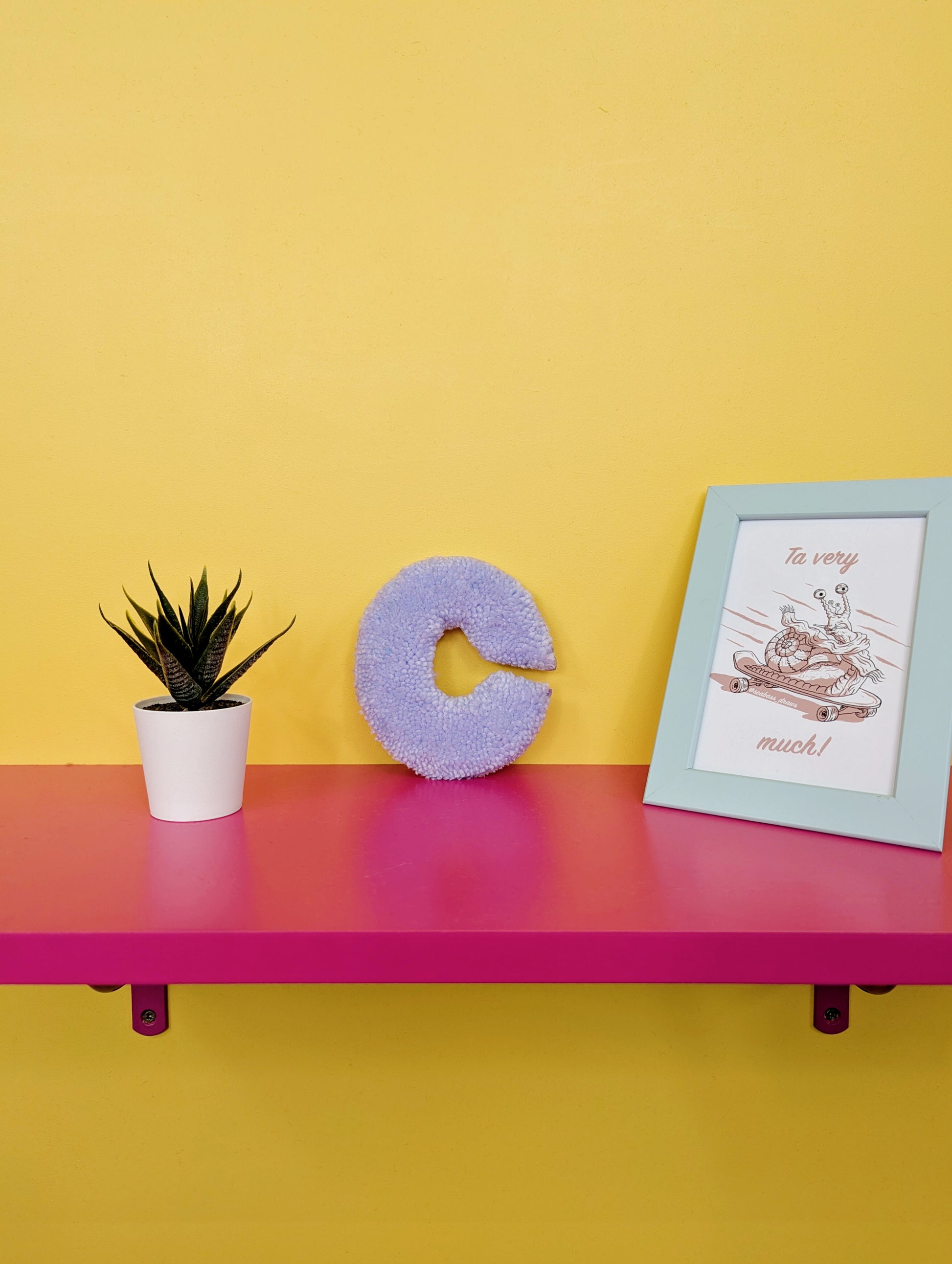 Soft tufted purple letter C with metal hook for easy hanging