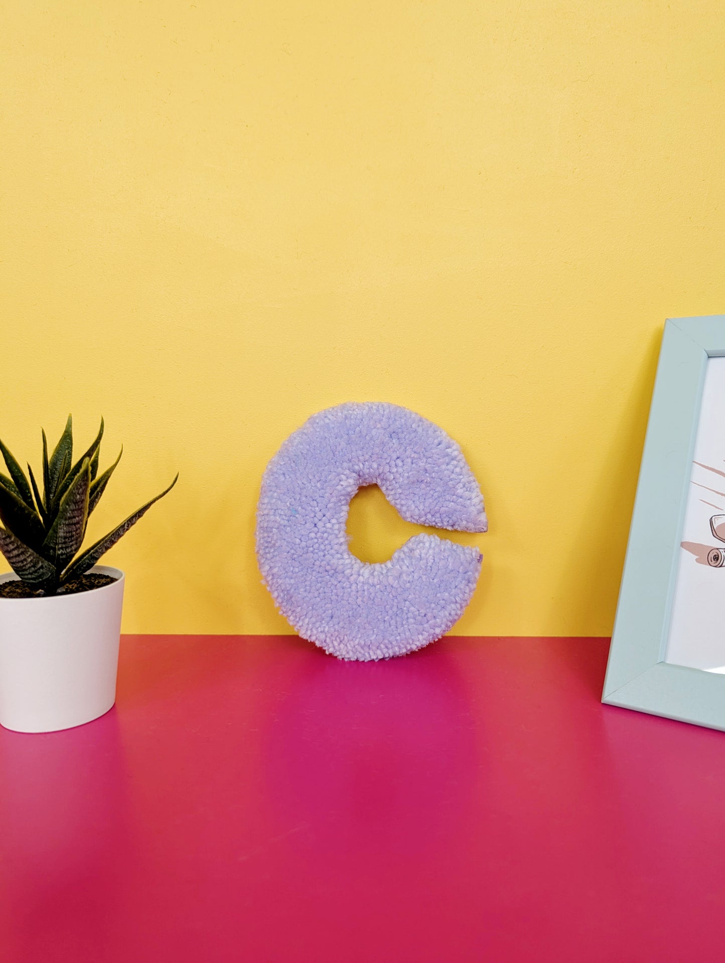 Soft tufted purple letter C with metal hook for easy hanging