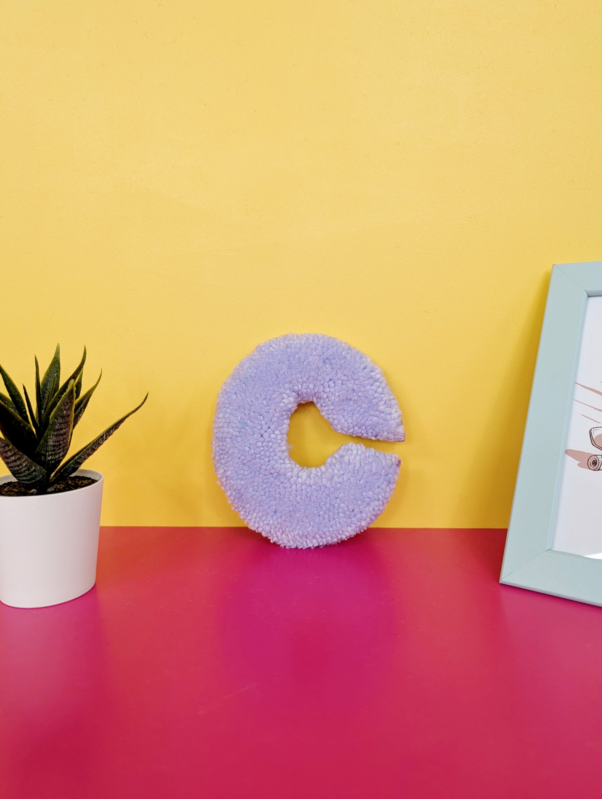 Soft tufted purple letter C with metal hook for easy hanging