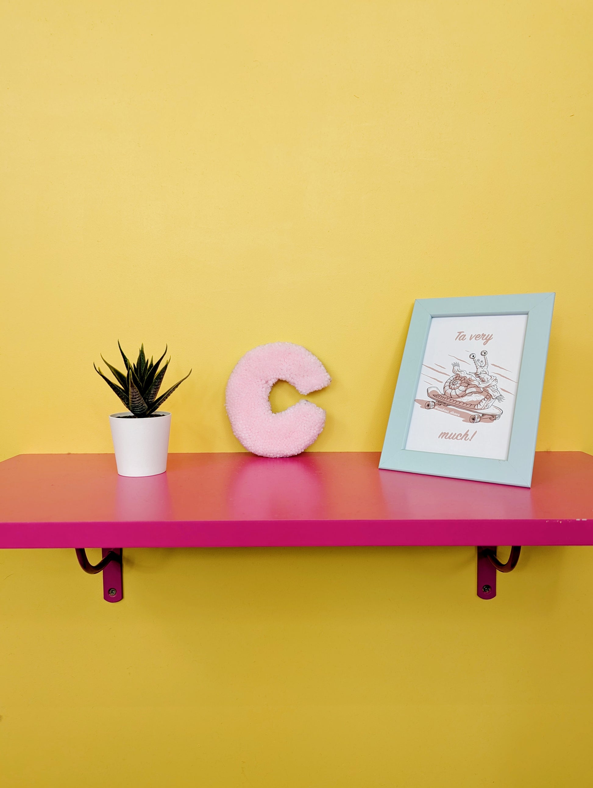 Soft tufted pink letter C with metal hook for easy hanging