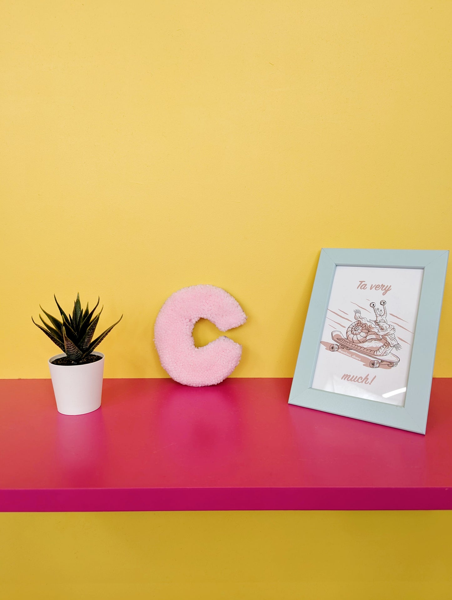 Soft tufted pink letter C with metal hook for easy hanging