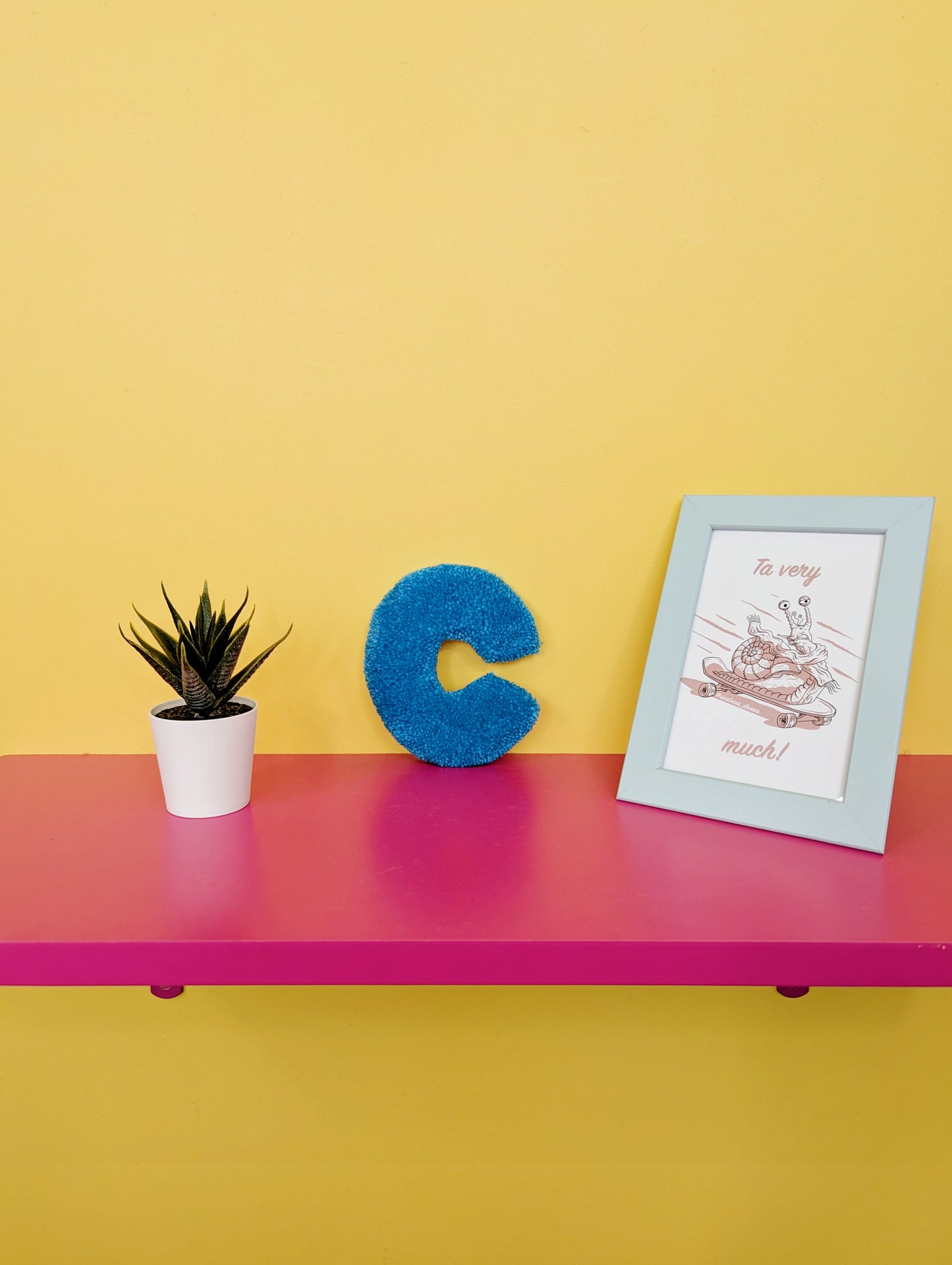 Soft tufted blue letter C with metal hook for easy hanging