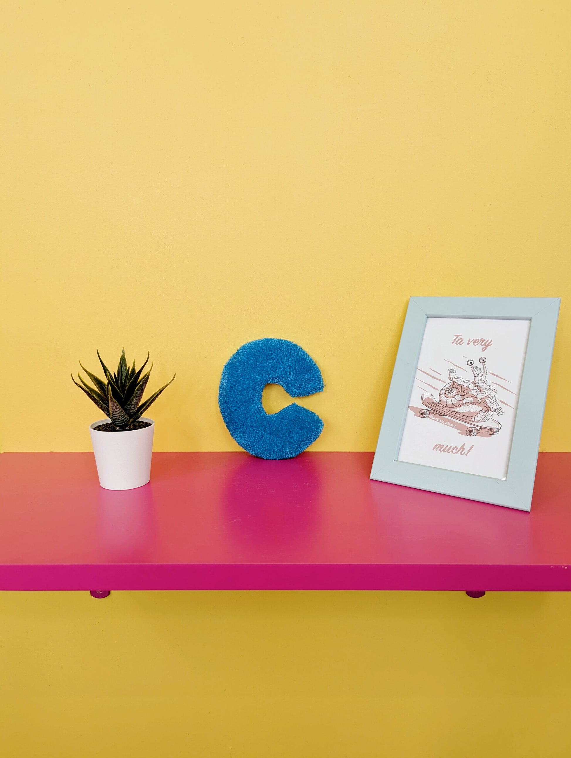 Soft tufted blue letter C with metal hook for easy hanging