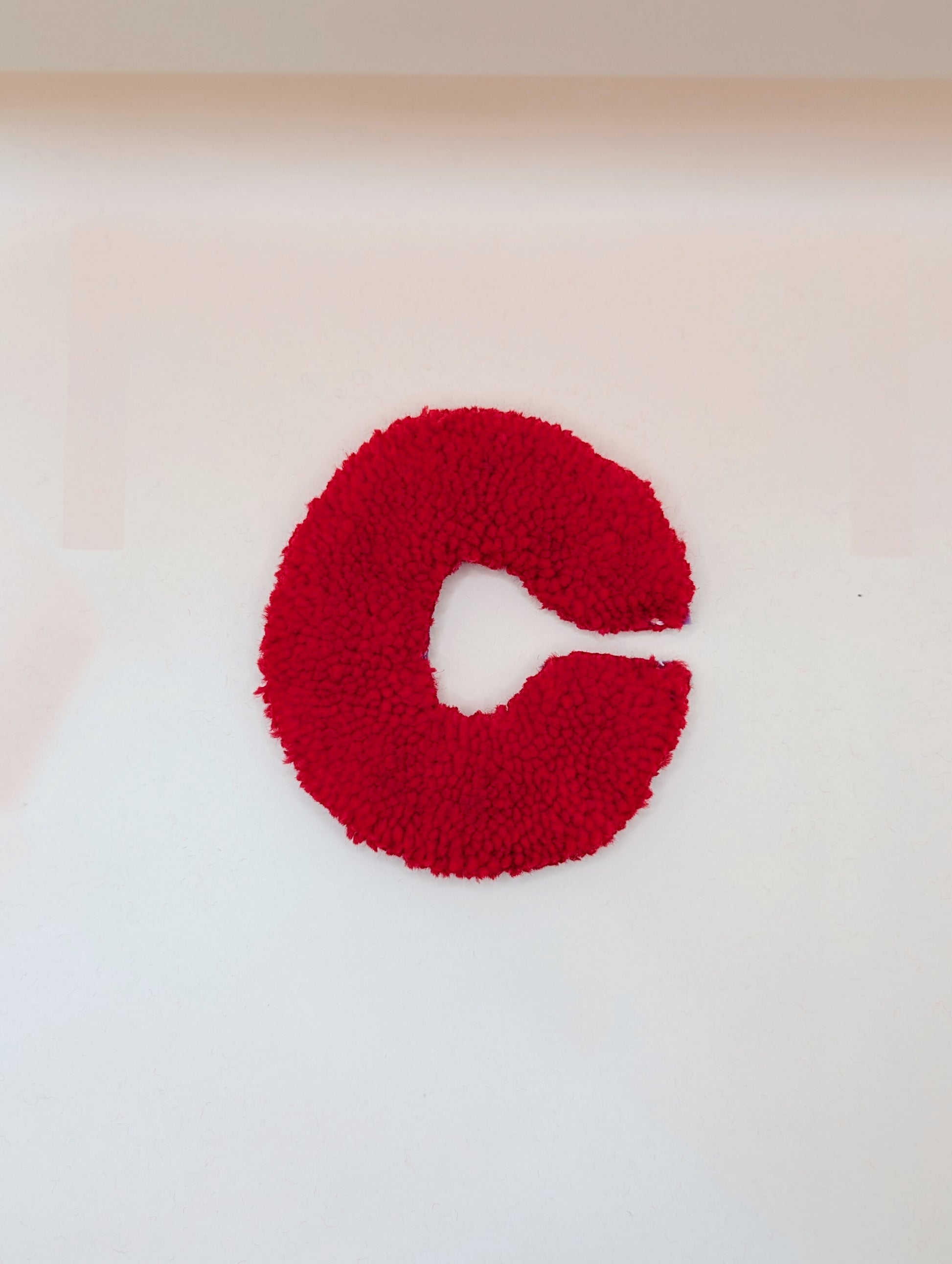 Soft tufted red letter C with metal hook for easy hanging