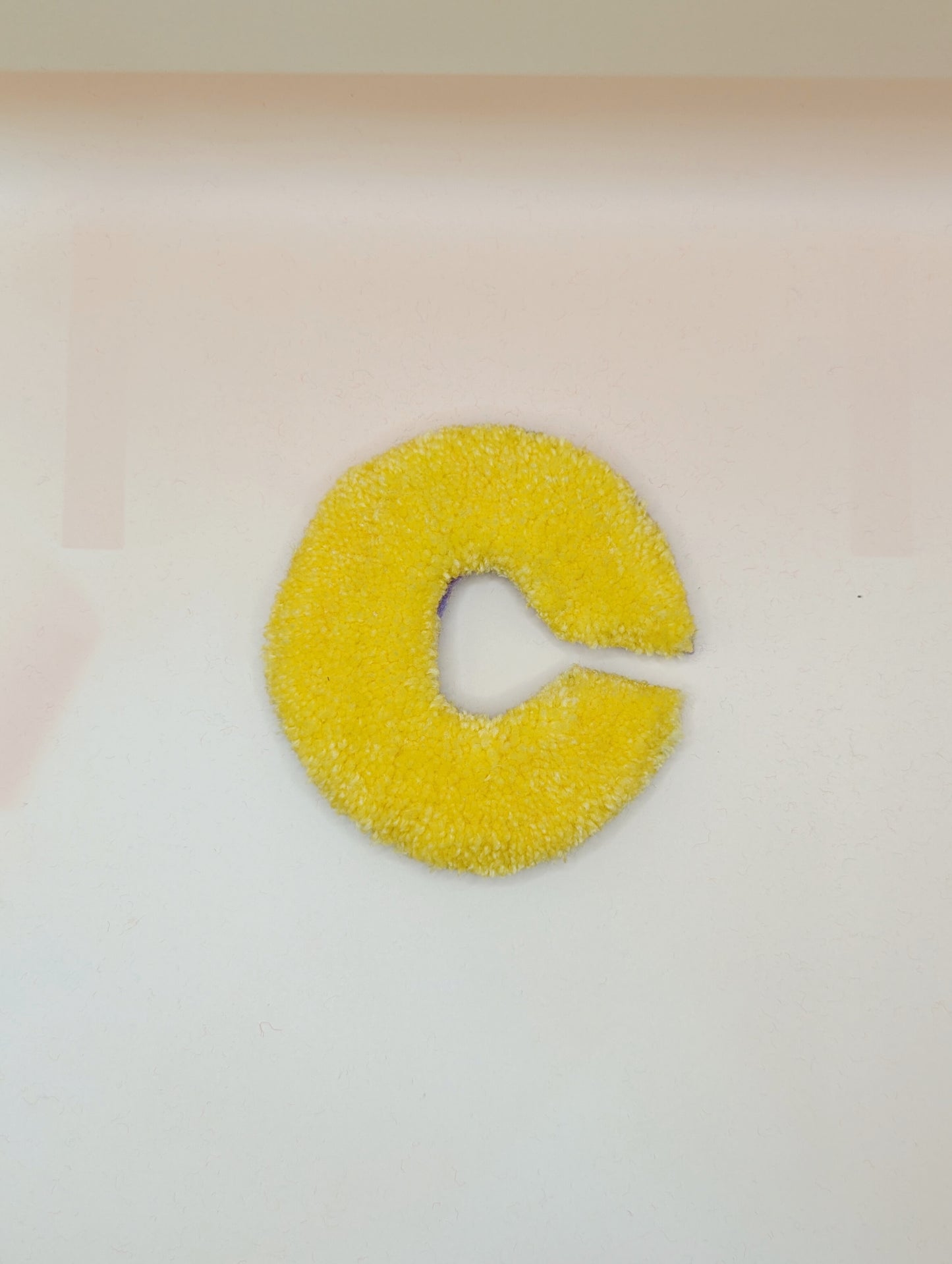 Soft tufted yellow letter C with metal hook for easy hanging