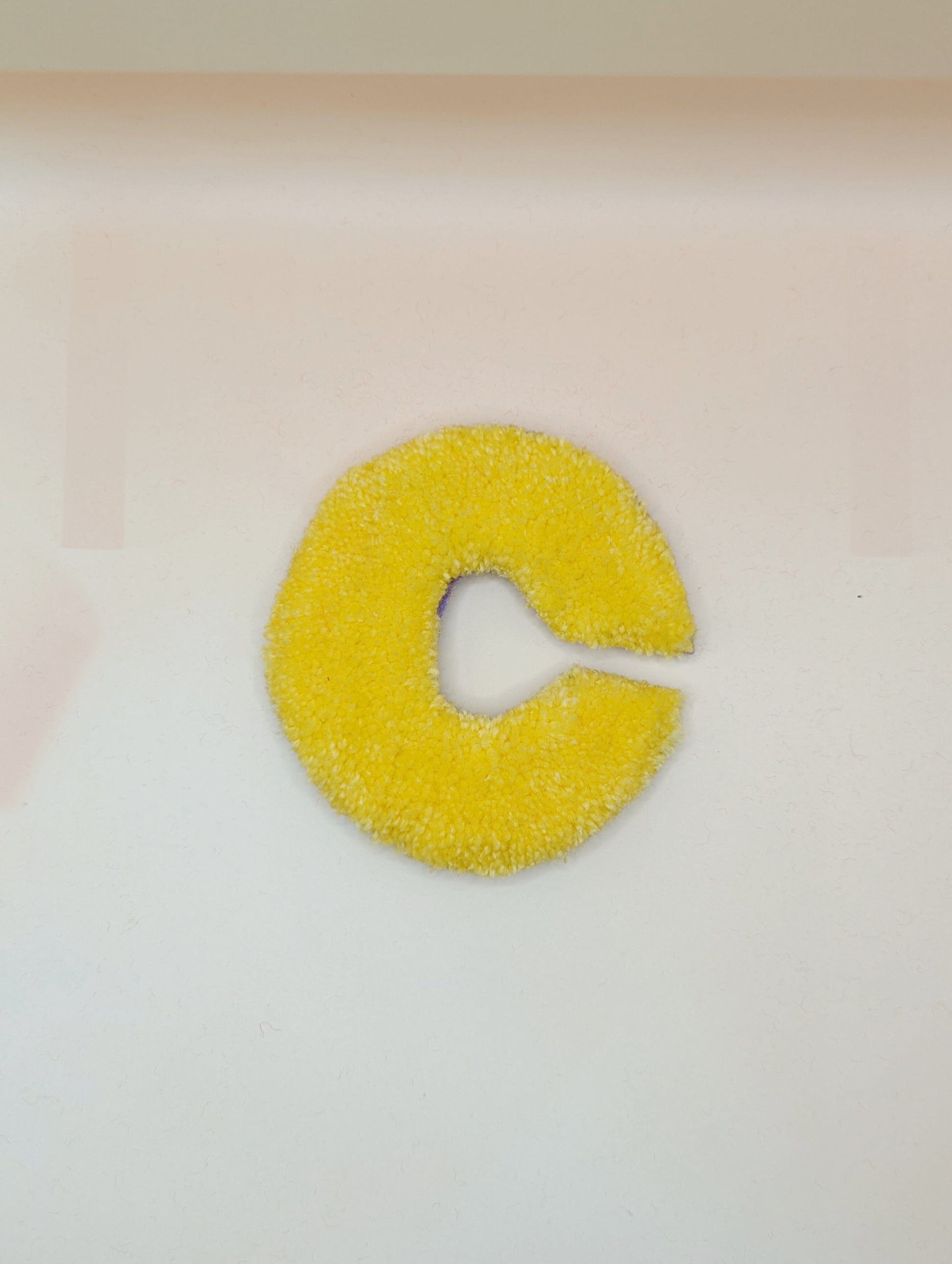 Soft tufted yellow letter C with metal hook for easy hanging