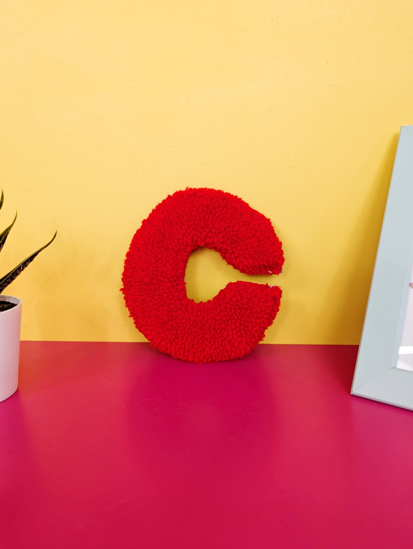 Soft tufted red letter C with metal hook for easy hanging
