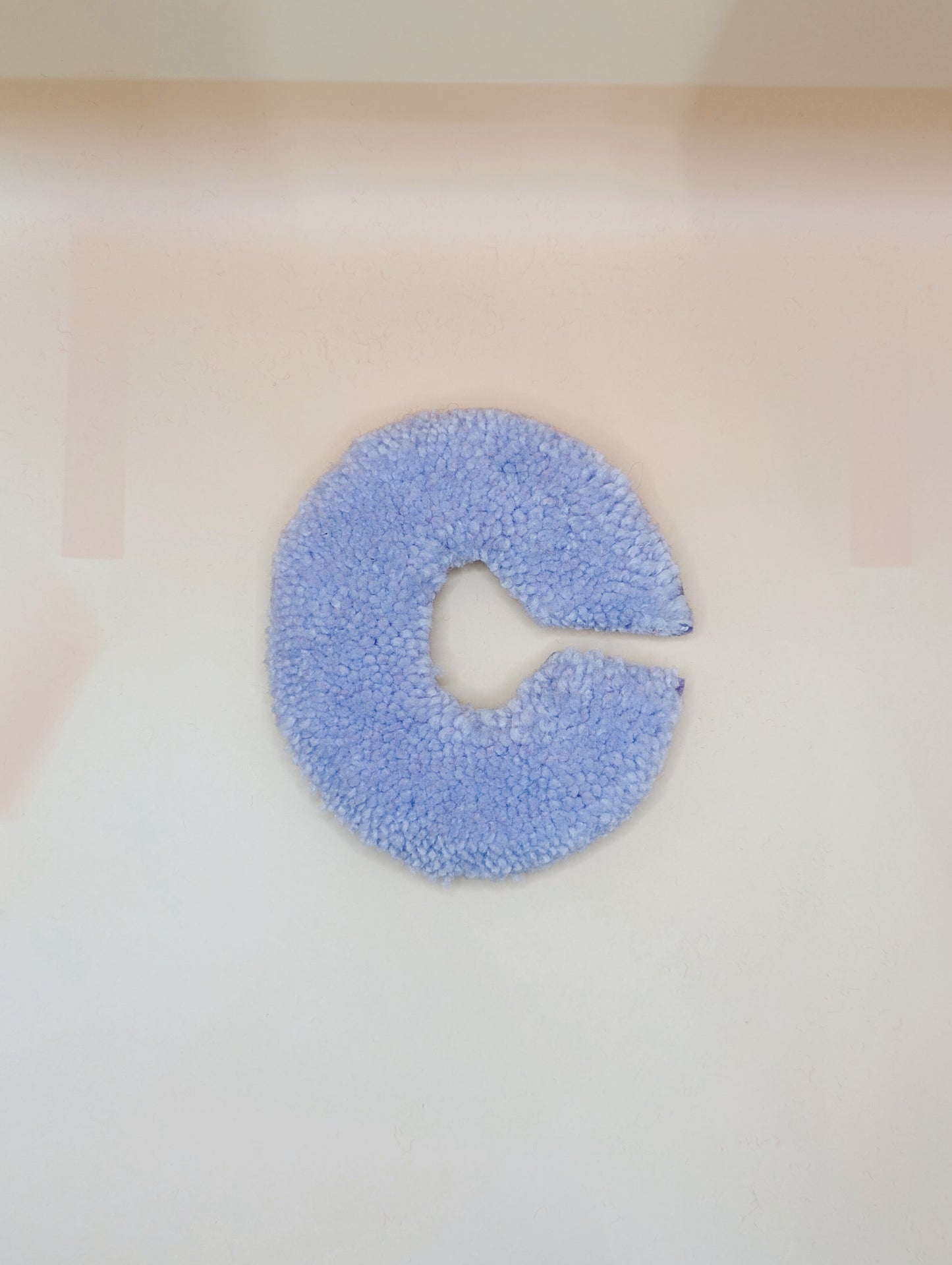 Soft tufted purple letter C with metal hook for easy hanging