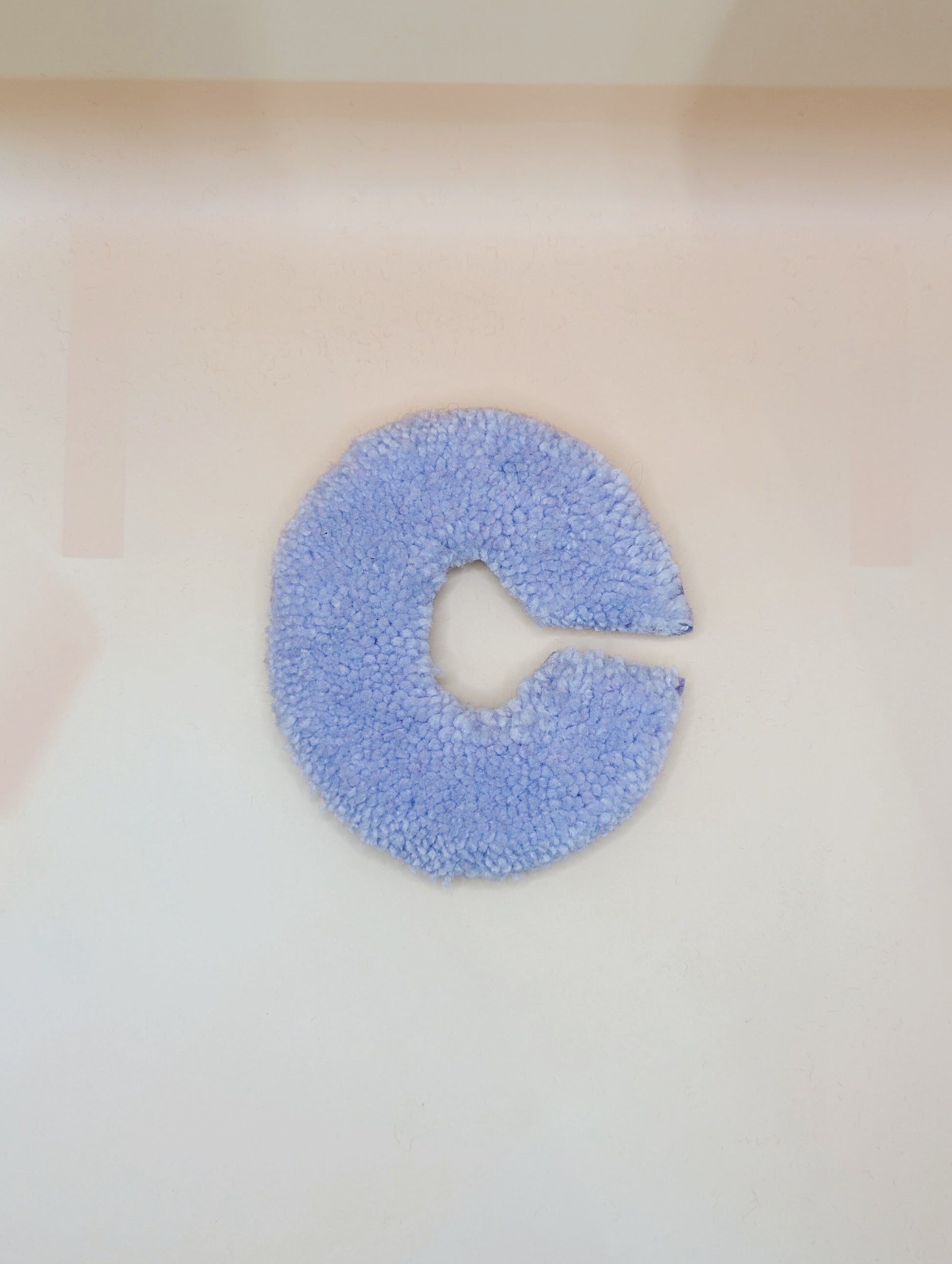 Soft tufted purple letter C with metal hook for easy hanging