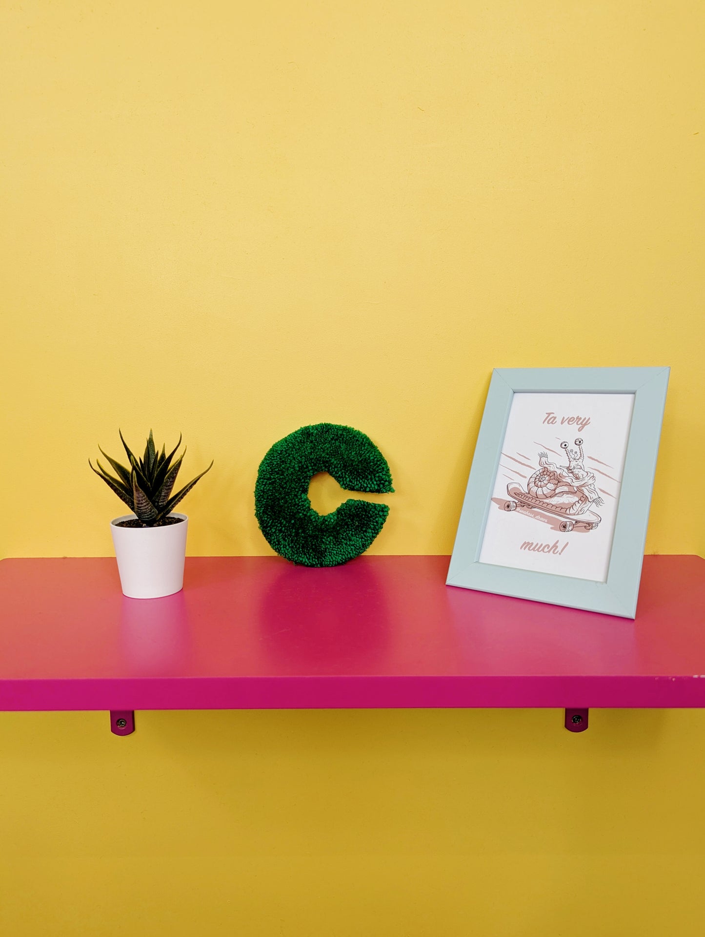 Soft tufted green letter C with metal hook for easy hanging