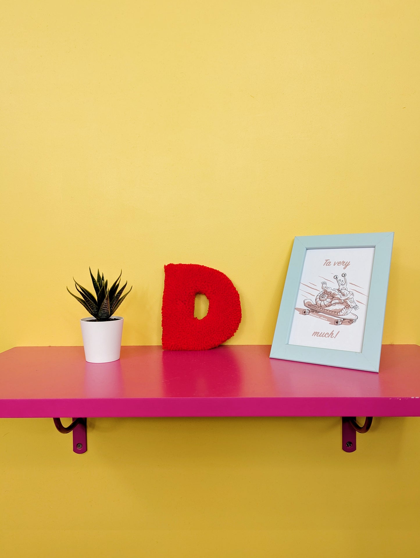 Soft tufted red letter D with metal hook for easy hanging