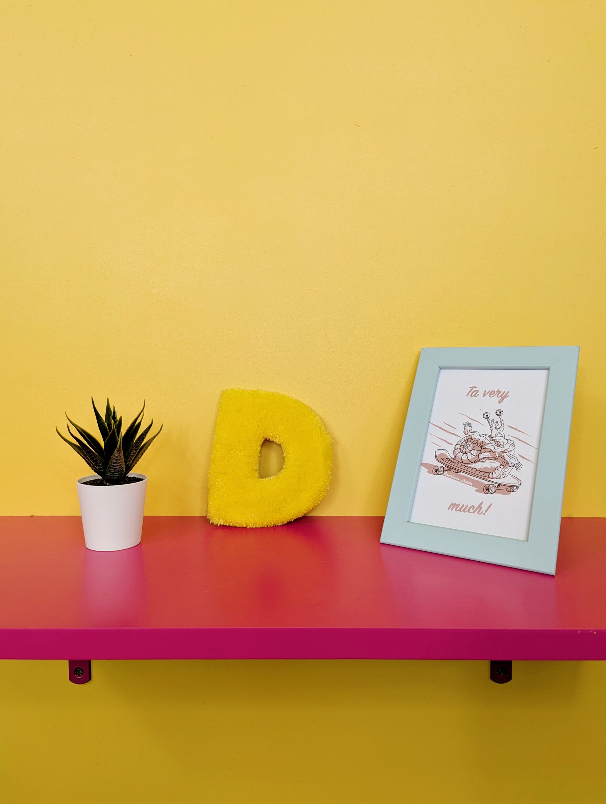 Soft tufted yellow letter D with metal hook for easy hanging