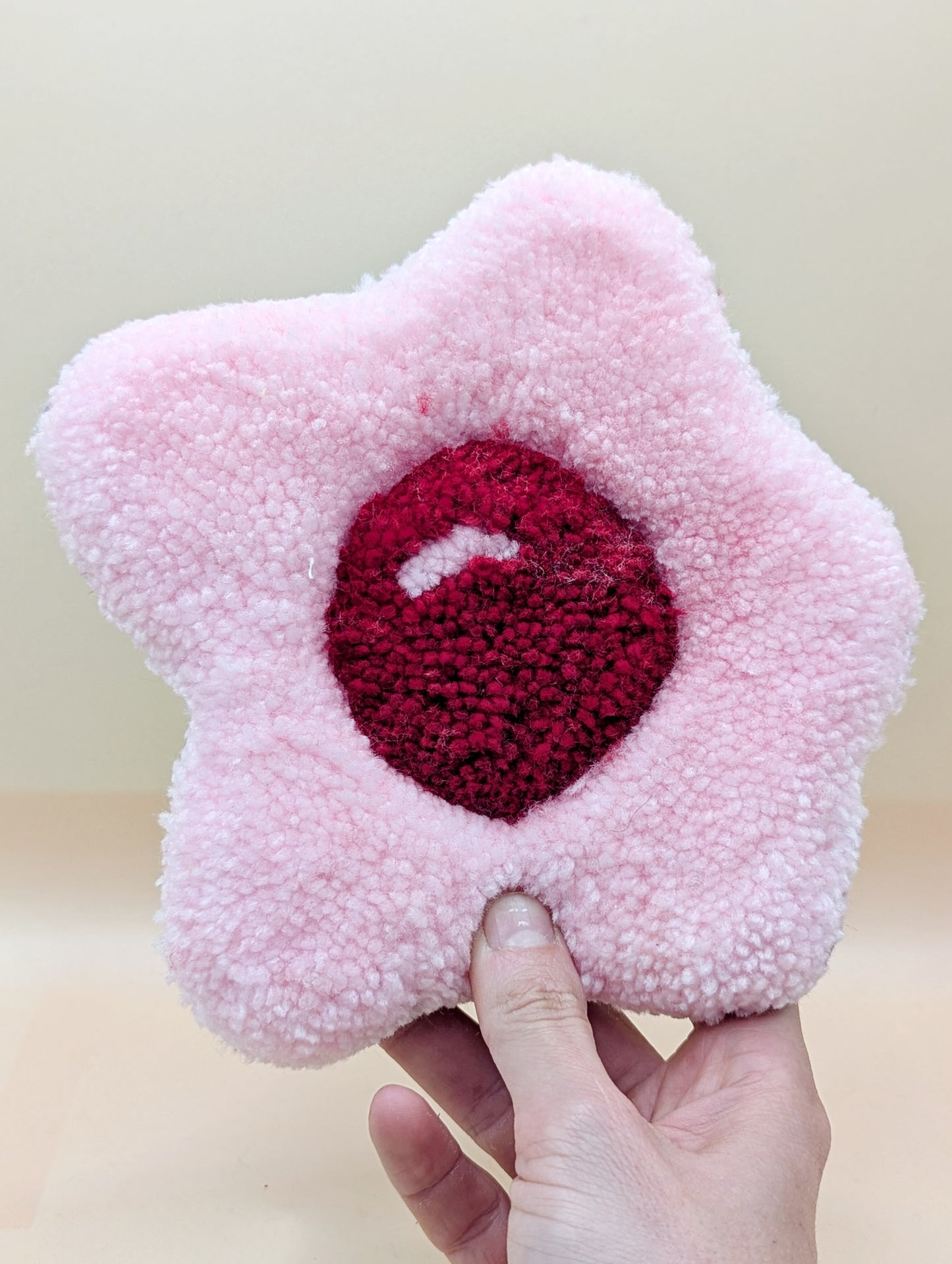 Soft tufted red and pink fried egg shaped mini rug/coaster 