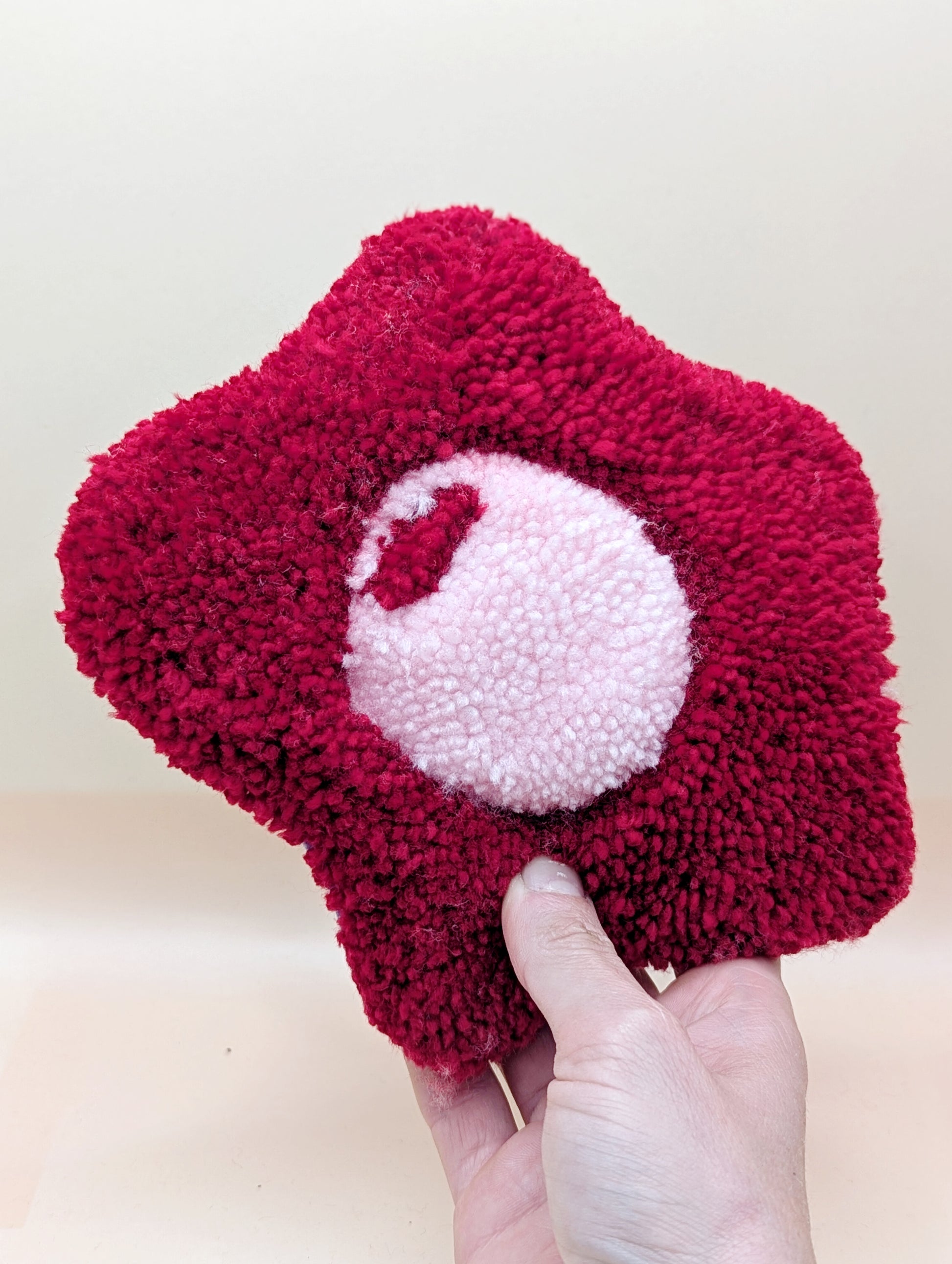 Soft tufted red and pink fried egg shaped mini rug/coaster 