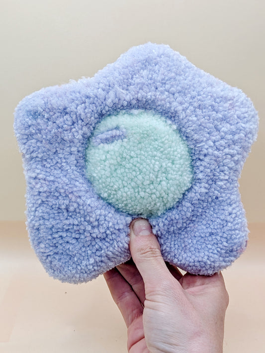 Soft tufted purple and red fried egg shaped mini rug/coaster 