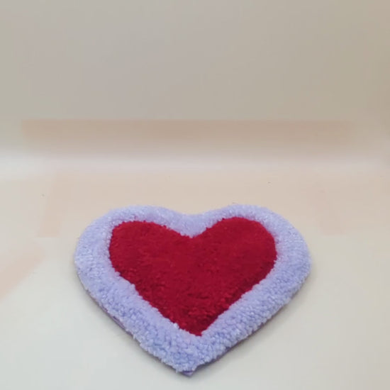 Soft tufted purple and red heart shaped mini rug/coaster 