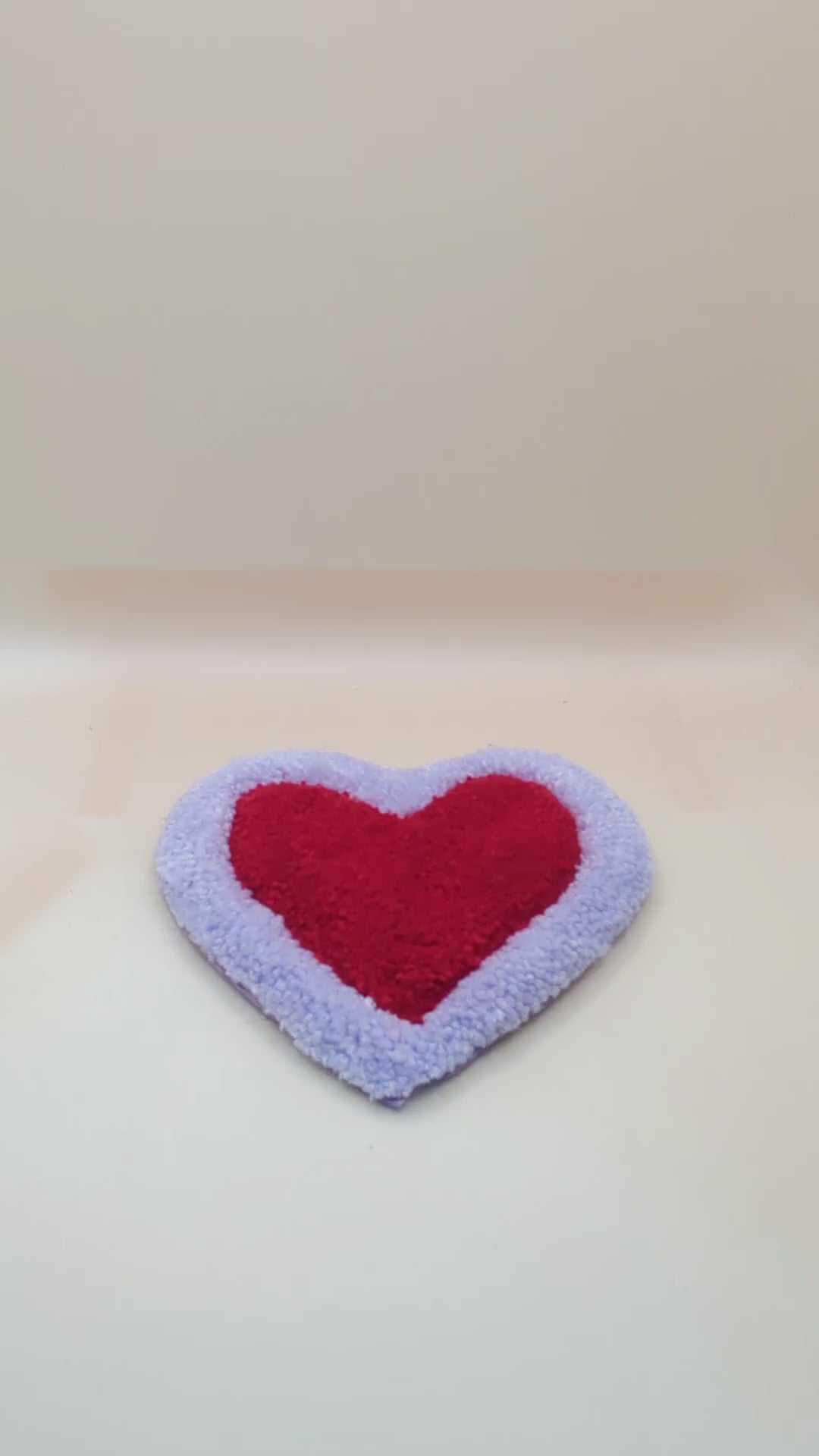 Soft tufted purple and red heart shaped mini rug/coaster 