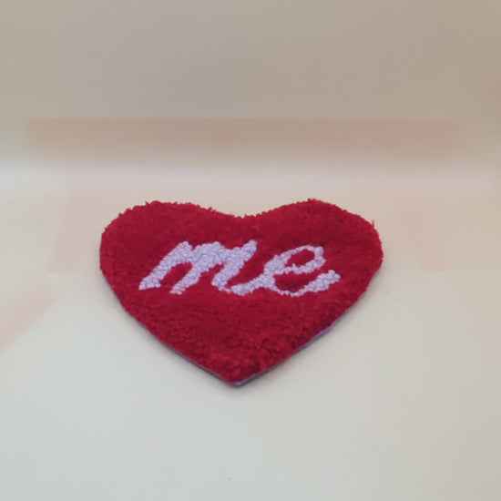 Soft tufted red and purple heart shaped mini rug/coaster with self love slogan