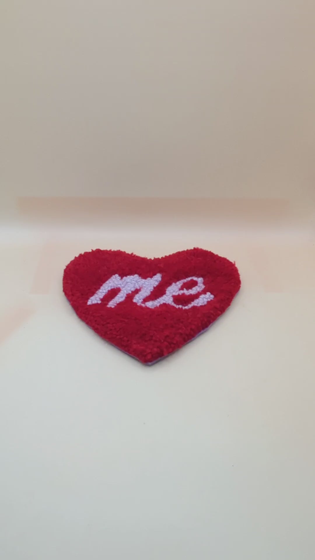 Soft tufted red and purple heart shaped mini rug/coaster with self love slogan