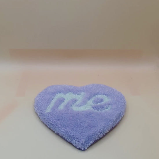 Soft tufted purple and green heart shaped mini rug/coaster with self love slogan