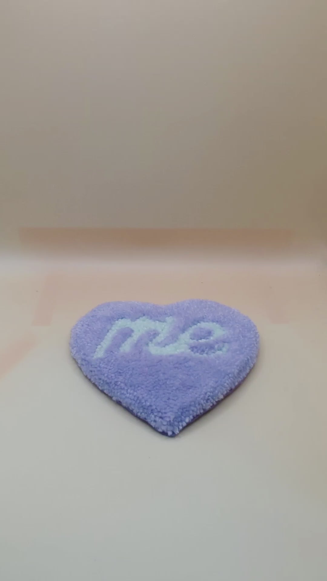 Soft tufted purple and green heart shaped mini rug/coaster with self love slogan