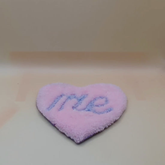 Soft tufted pink and purple heart shaped mini rug/coaster with self love slogan