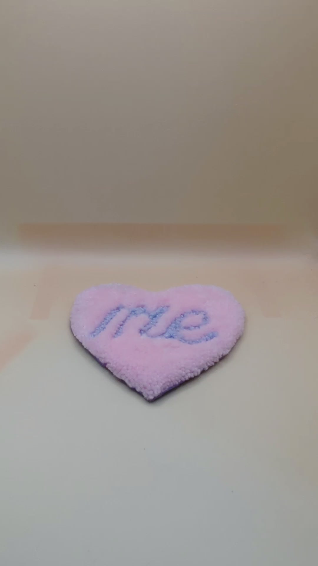 Soft tufted pink and purple heart shaped mini rug/coaster with self love slogan