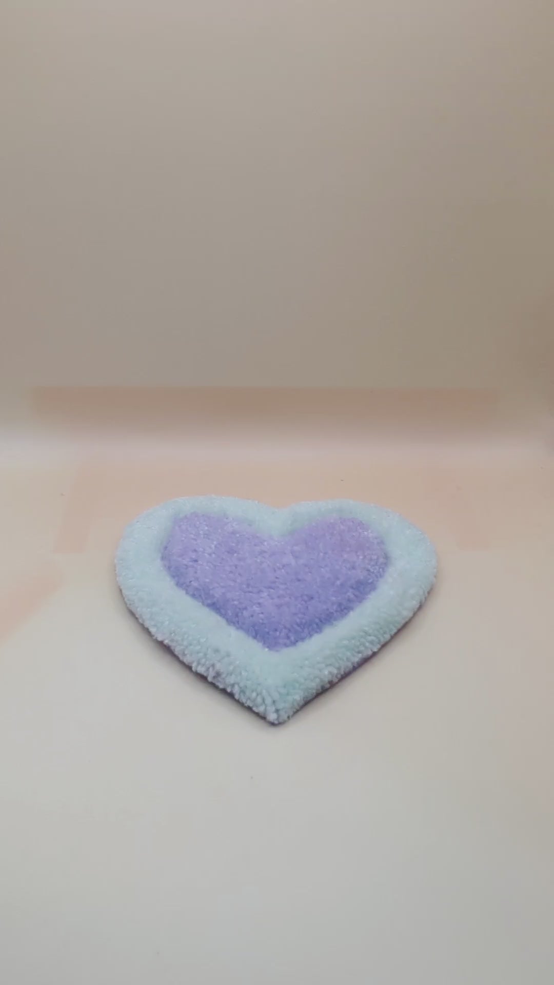 Soft tufted green and purple heart shaped mini rug/coaster 