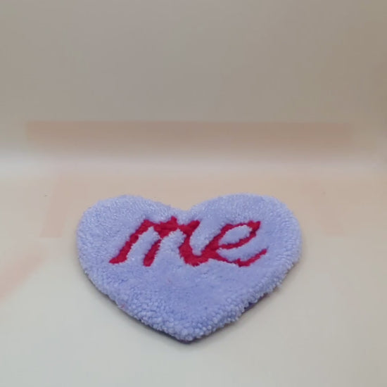 Soft tufted purple and red heart shaped mini rug/coaster with self love slogan