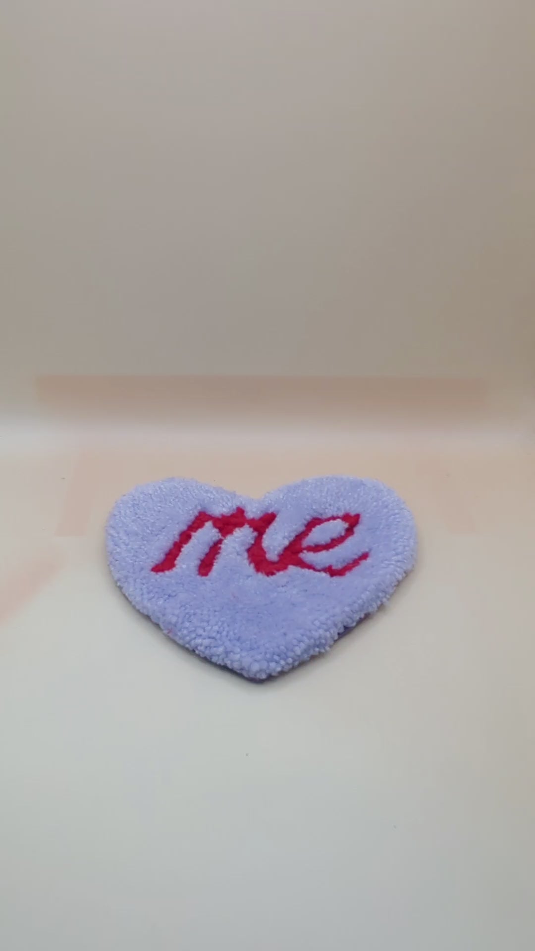 Soft tufted purple and red heart shaped mini rug/coaster with self love slogan
