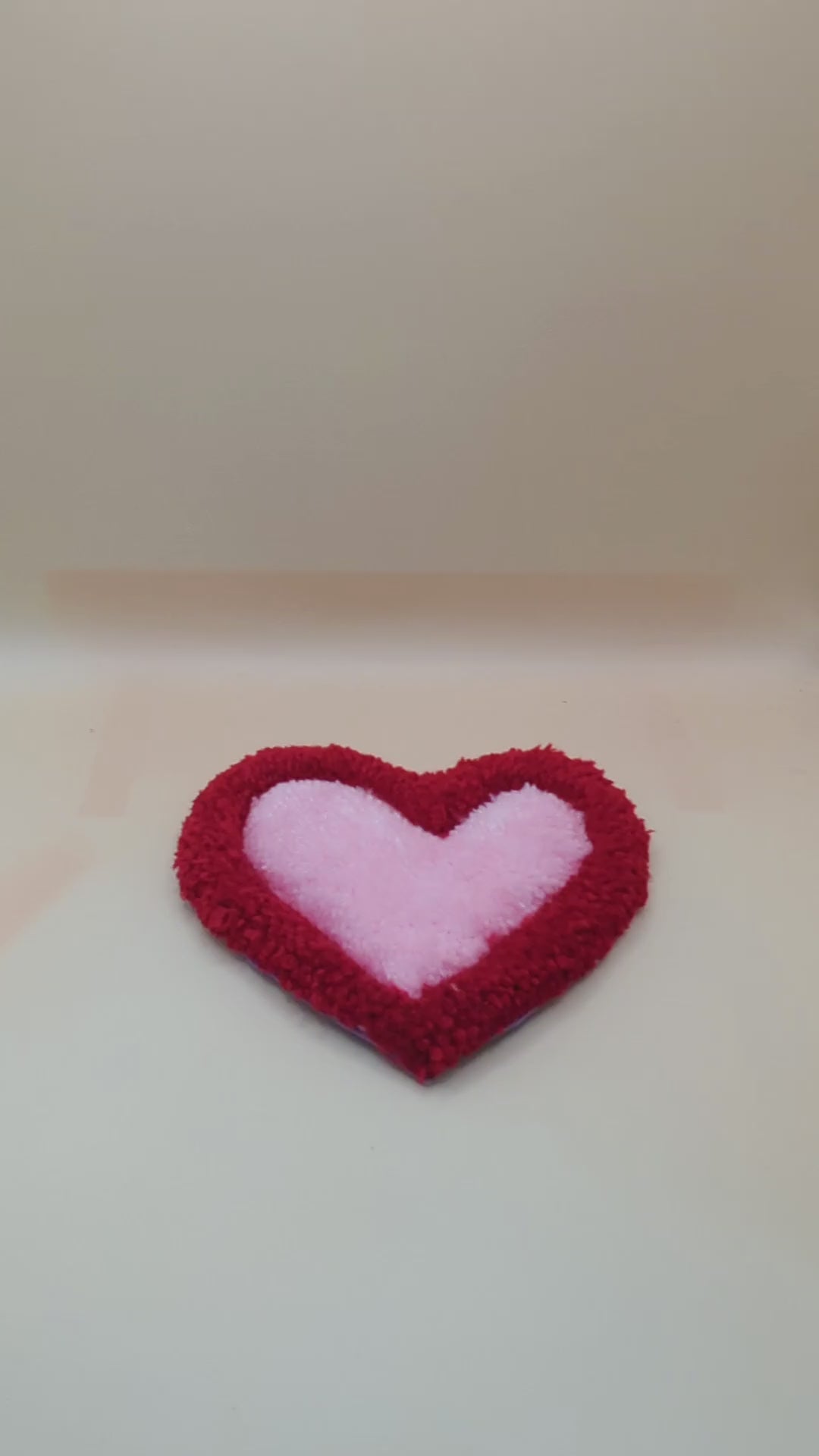 Soft tufted red and pink heart shaped mini rug/coaster 