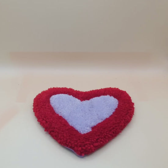 Soft tufted red and purple heart shaped mini rug/coaster 