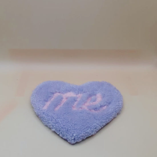 Soft tufted purple and pink heart shaped mini rug/coaster with self love slogan