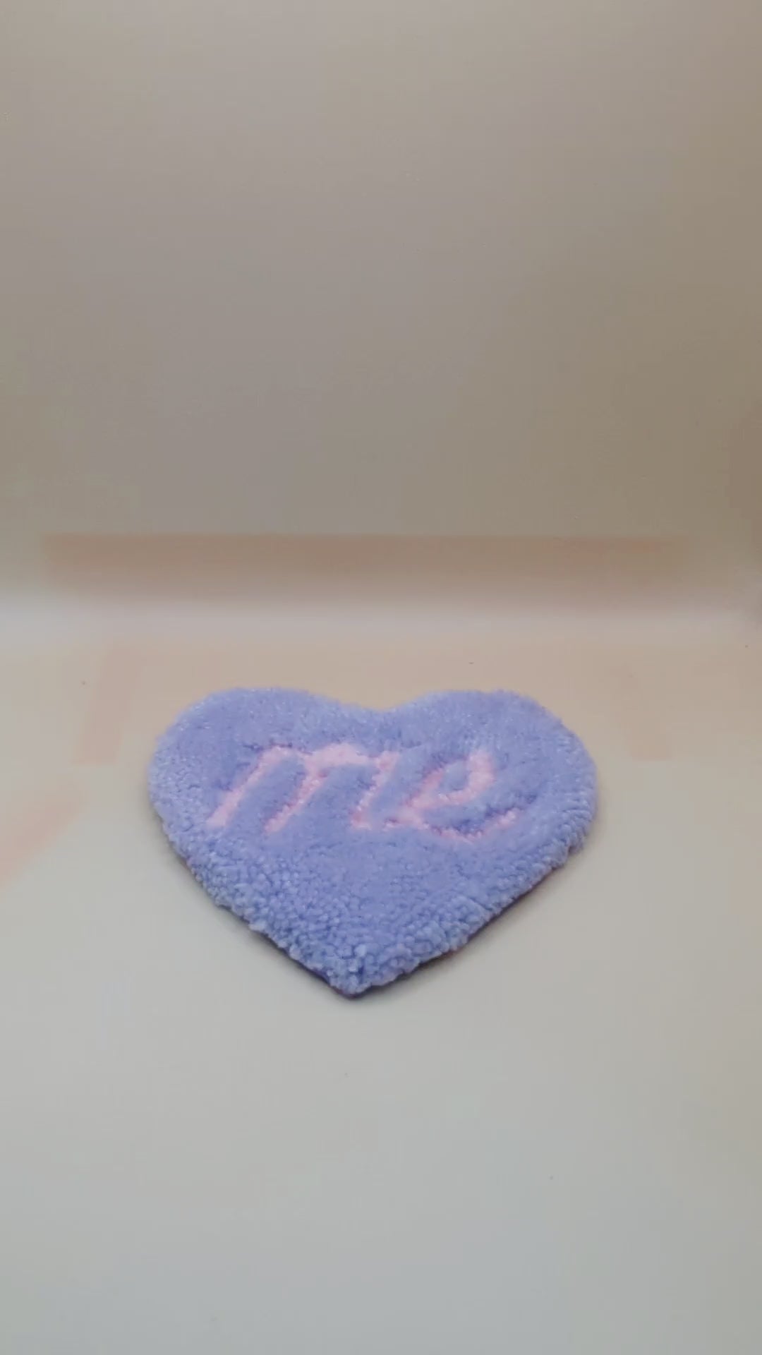 Soft tufted purple and pink heart shaped mini rug/coaster with self love slogan