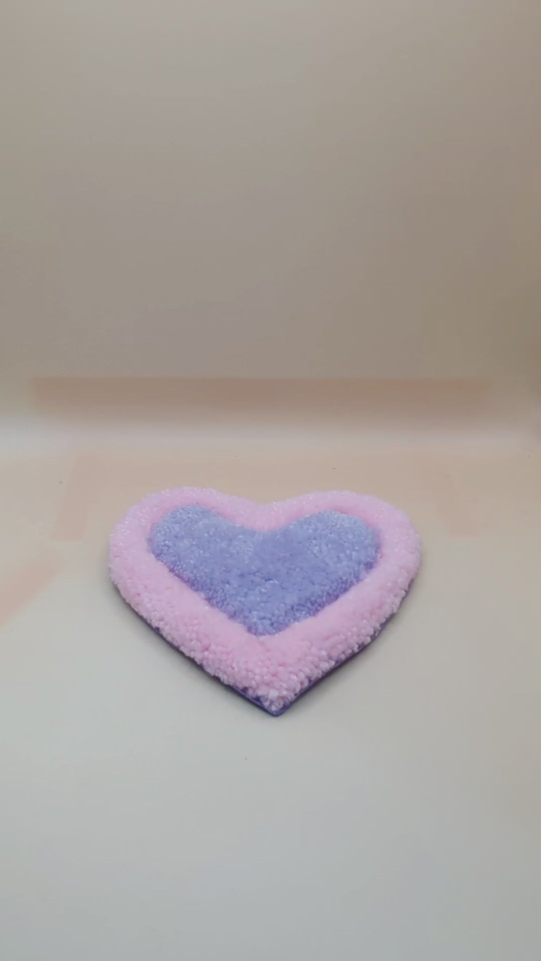 Soft tufted pink and purple heart shaped mini rug/coaster 