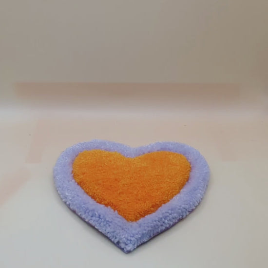 Soft tufted purple and orange heart shaped mini rug/coaster 