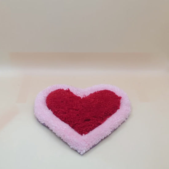 Soft tufted pink and red heart shaped mini rug/coaster 