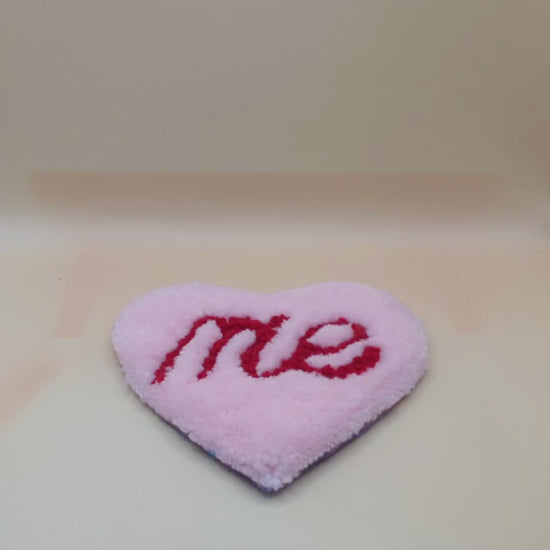 Soft tufted pink and red heart shaped mini rug/coaster with self love slogan