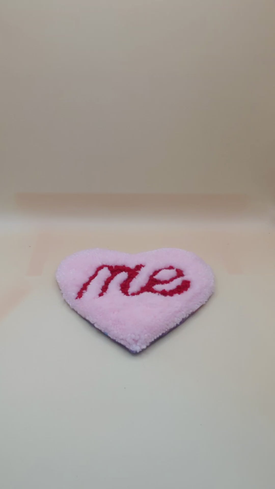 Soft tufted pink and red heart shaped mini rug/coaster with self love slogan